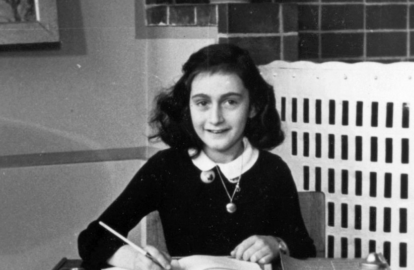 Anne Frank at her writing table in 1940; how many Anne Franks were lost in the Holocaust? (photo credit: Wikimedia Commons)