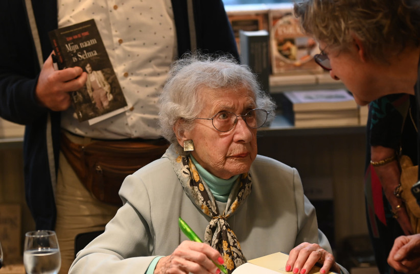Selma van de Perre signs her book at the National Holocaust Museum in Amsterdam, Jan. 9, 2020 (photo credit: CNAAN LIPHSHIZ/JTA)