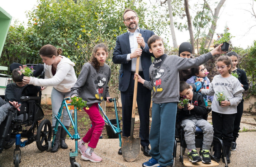EU Ambassador to Israel Emanuele Giaufret plants tree with disabled children (photo credit: RONI KAUFMAN)