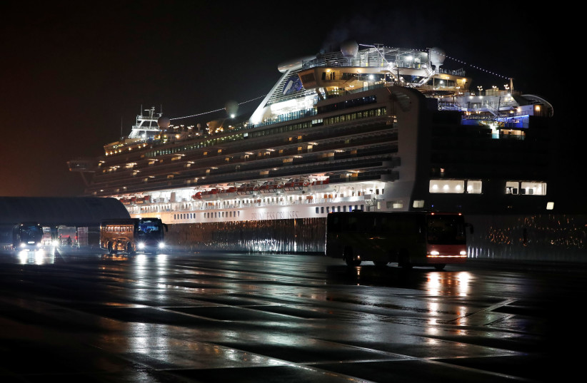 Buses believed to carry the U.S. passengers of the cruise ship Diamond Princess, where dozens of passengers were tested positive for coronavirus, leave at Daikoku Pier Cruise Terminal in Yokohama, south of Tokyo (photo credit: REUTERS)