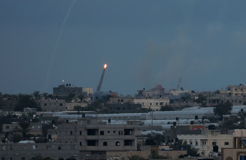A rocket is fired towards Israel, in the southern Gaza Strip February 24, 2020 (photo credit: REUTERS/IBRAHEEM ABU MUSTAFA)
