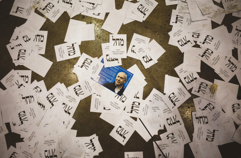 LIKUD ELECTION ballots are seen on the floor at party headquarters in Tel Aviv, Monday night. (photo credit: AMIR COHEN/REUTERS)