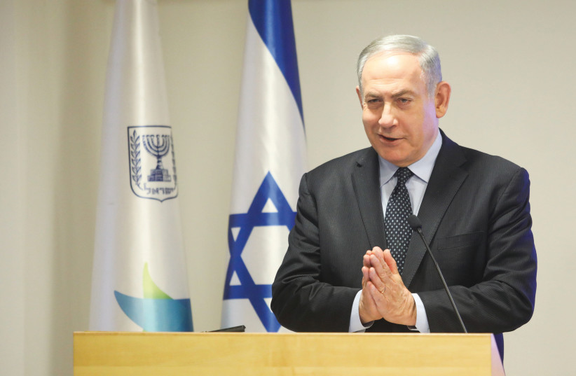Prime Minister Benjamin Netanyahu recommends Israelis use the namaste greeting to avoid contracting coronavirus at a press conference in Jerusalem on March 4 (photo credit: MARC ISRAEL SELLEM)