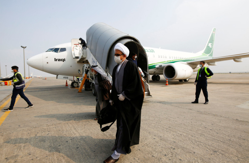 A cleric man wears a protective mask amid concerns over the coronavirus (COVID-19) spread, at Najaf airport in the holy city of Najaf upon his arrival from Iran (photo credit: REUTERS/ALAA AL-MARJANI)