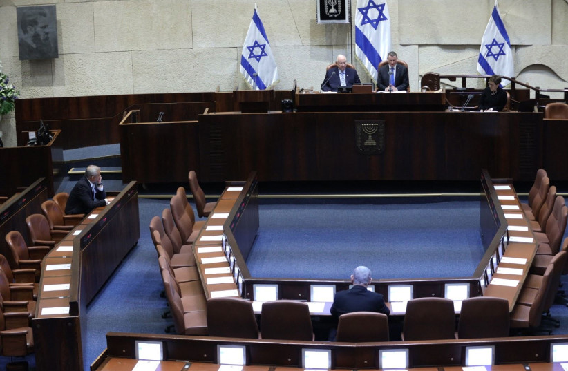 Blue and White leader Benny Gantz (L) and Prime Minister Benjamin Netanyahu (C) sit in an empty hall in front of President Reuven Rivlin and Knesset Speaker Yuli Edelstein at the swearing in of the 23rd Knesset, March 16, 2020 (photo credit: HAIM ZACH/GPO)