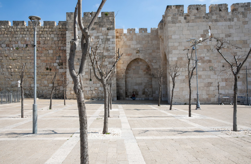 General view of the empty square outside the Jaffa Gate in the Old City of Jerusalem on March 16, 2020. For Fear of Coronavirus, Israel Closes all Borders decreasing the number of tourits. The government orders all bars, restaurants and malls to close in an effort to contain the spread of virus. (photo credit: OLIVIER FITOUSSI/FLASH90)
