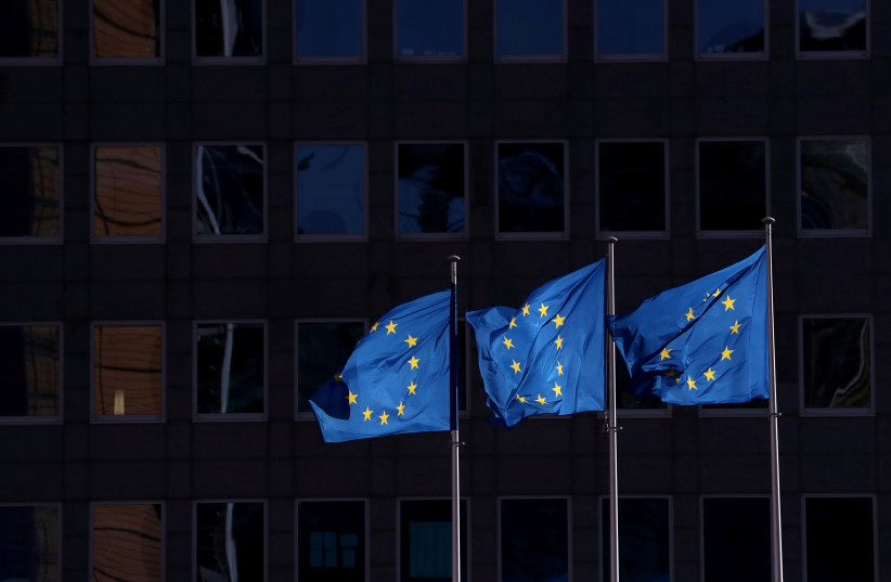 European Union flags fly outside the European Commission headquarters in Brussels (photo credit: YVES HERMAN/REUTERS)
