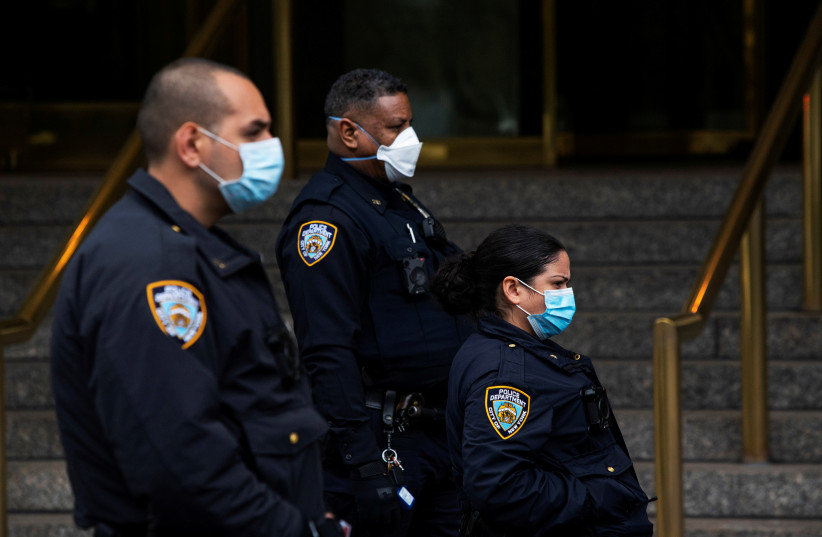New York Police officers wear protective masks, New York, U.S., April 18, 2020 (photo credit: EDUARDO MUNOZ / REUTERS)