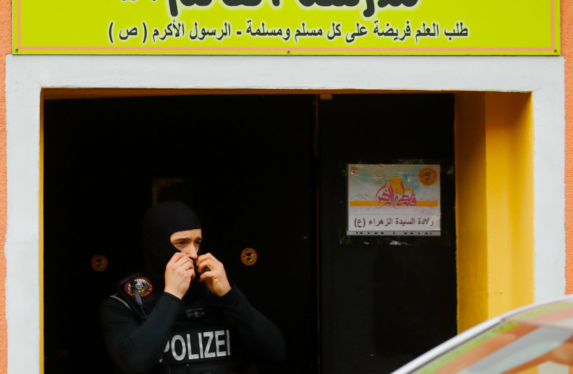  German special police leaves the El-Irschad (Al-Iraschad e.V.) centre in Berlin, Germany, April 30, 2020, after Germany has banned Iran-backed Hezbollah on its soil and designated it a terrorist organisation (photo credit: REUTERS/HANNIBAL HANSCHKE)