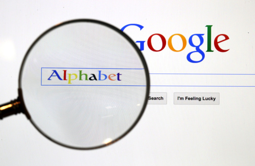 A Google search page is seen through a magnifying glass in this photo illustration taken in Berlin, August 11, 2015 (photo credit: REUTERS/PAWEL KOPCZYNSKI)