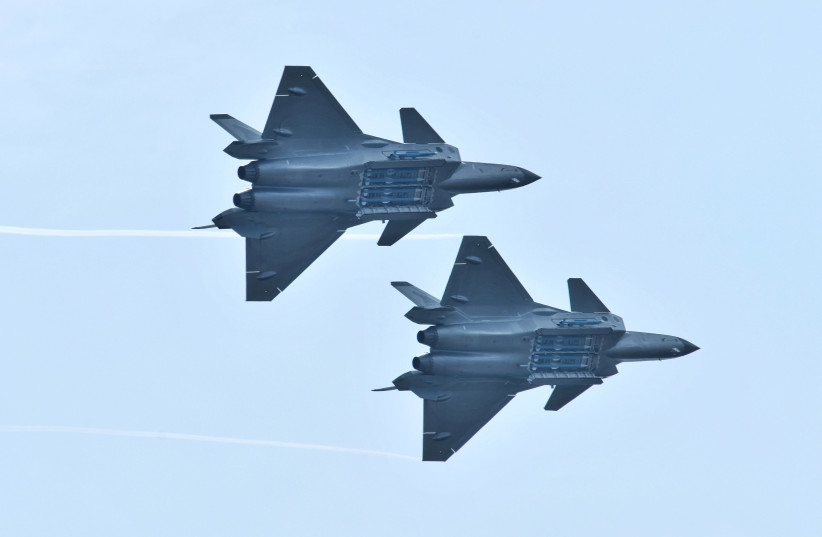 Chengdu J-20 stealth fighter jets of Chinese People's Liberation Army (PLA) Air Force perform with open weapon bays during the China International Aviation and Aerospace Exhibition, or Zhuhai Airshow, in Zhuhai, Guangdong province, China November 11, 2018. (photo credit: STRINGER/ REUTERS)
