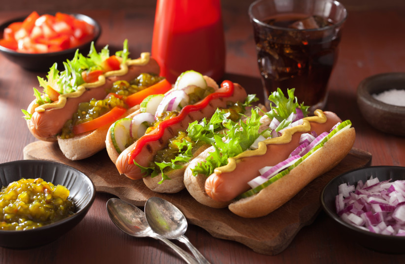 Grilled hot dogs with vegetables, ketchup and mustard (illustration) (photo credit: INGIMAGE)
