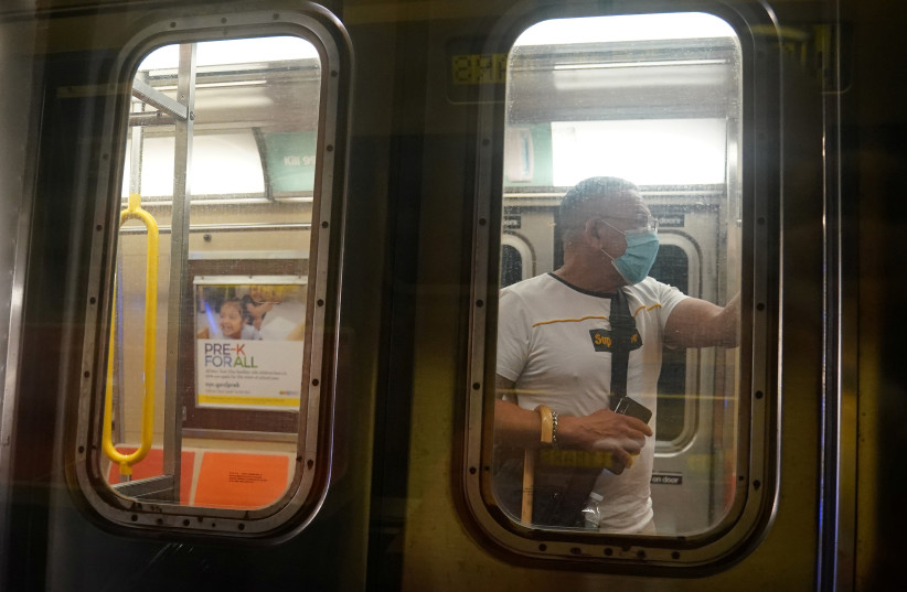 A man rides a subway in the Manhattan borough of New York City, New York, U.S., June 25, 2020. (photo credit: REUTERS/CARLO ALLEGRI)