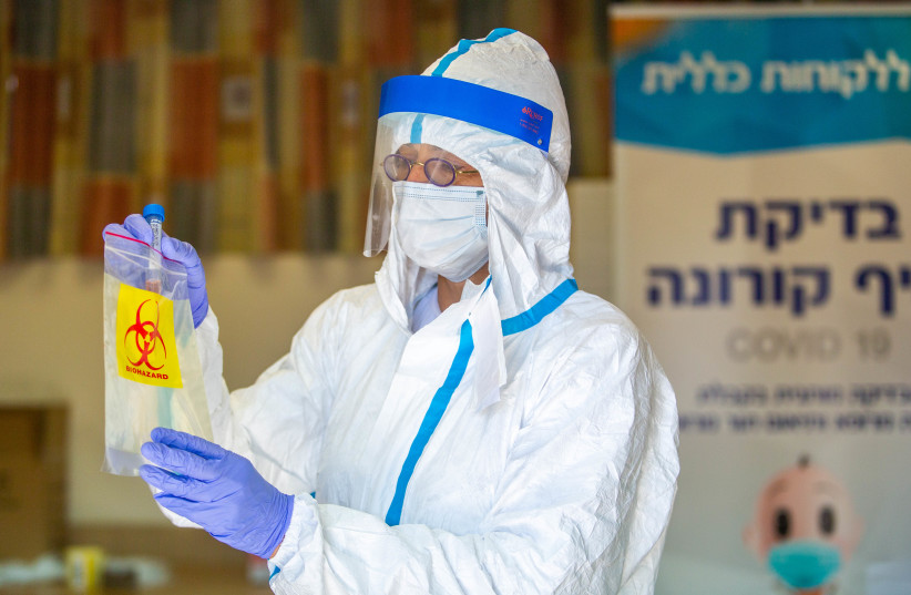 Health care workers take test samples to check for coronavirus, Lod, July 5, 2020 (photo credit: YOSSI ALONI/FLASH90)