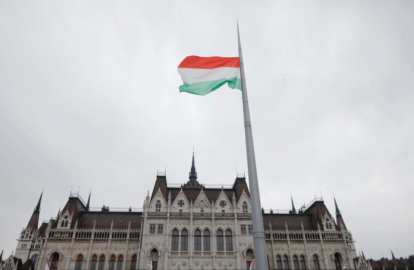A Hungarian national flag flutters outside the Hungarian parliament building at a pro-Orban rally during Hungary's National Day celebrations, which also commemorates the 1848 Hungarian Revolution against the Habsburg monarchy, in Budapest, Hungary, March 15, 2018.  (photo credit: REUTERS)