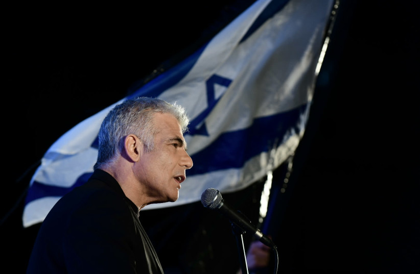 MK Yair Lapid speaks during a protest against Prime Minister Benjamin Netanyahu calling on him to quit, at Rabin Square in Tel Aviv on April 19, 2020 (photo credit: TOMER NEUBERG/FLASH90)