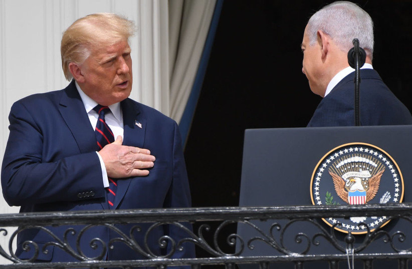 President Donald Trump talks to Israeli Prime Minister Benjamin Netanyahu from the Truman Balcony at the White House during the signing ceremony of the Abraham Accords, Sept. 15, 2020 (photo credit: SAUL LOEB/AFP VIA GETTY IMAGES/JTA)