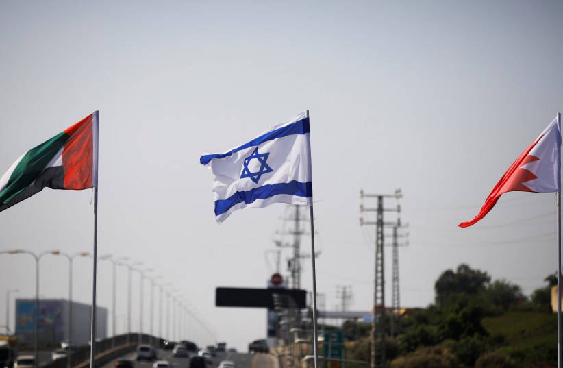 The flags of the United Arab Emirates, Israel and Bahrain flutter along a road in Netanya, Israel September 14, 2020 (photo credit: REUTERS/NIR ELIAS)