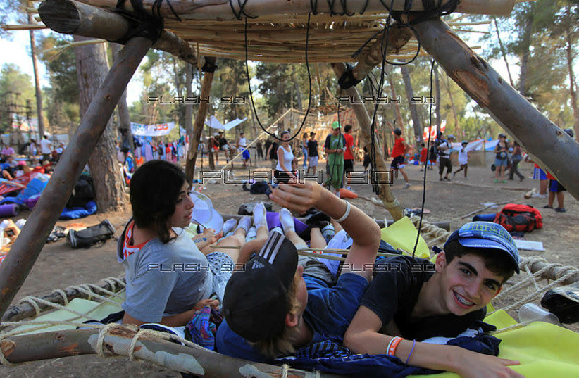 YOUNG ISRAELI scouts play at a summer camp in the Haruvit forest. (Illustrative of Zionist American summer camps. (photo credit: NATI SHOHAT/FLASH90)
