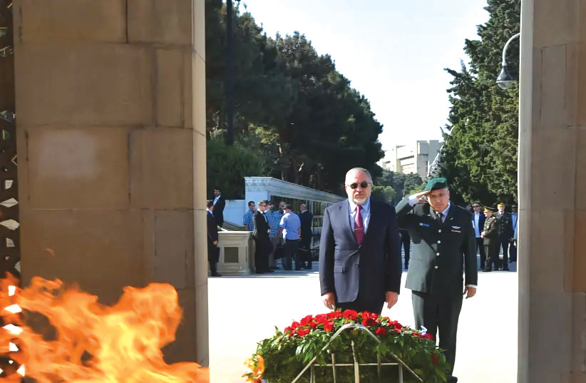 THEN-DEFENSE Minister Avigdor Liberman on a visit to Azerbaijan, visiting the Eternal Fire memorial in Baku, in 2018.  (photo credit: ARIEL HERMONI / DEFENSE MINISTRY)
