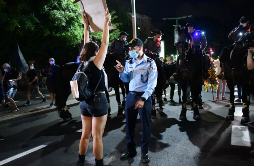 Anti-Netanyahu protester in Tel Aviv confronts Israel Police (photo credit: AVSHALOM SASSONI)