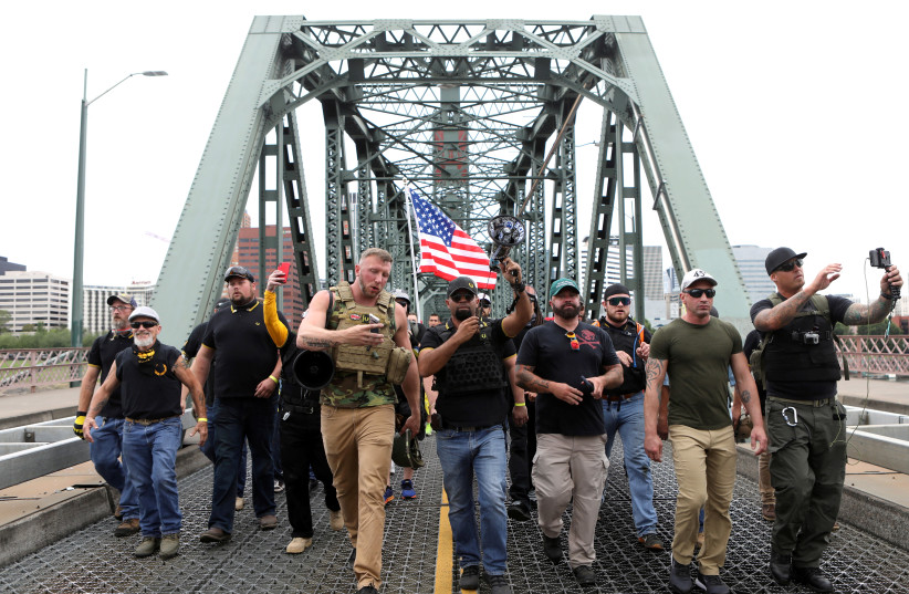 Members of the Proud Boys and their supporters march during a rally in Portland, Oregon (photo credit: REUTERS)