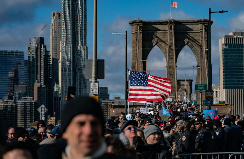 Participants in a Jewish solidarity march across New York City's Brooklyn Bridge, Jan. 5, 2020. The march in the city was held in response to a recent rise in anti-Semitic crimes in the New York metropolitan area. (Jeenah Moon/Getty Images) (photo credit: JEENAH MOON)