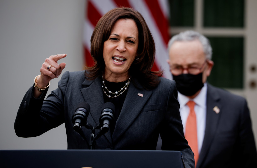 US Vice President Kamala Harris speaks about the $1.9 trillion "American Rescue Plan Act" as Senate Majority Leader Chuck Schumer (D-NY) listens during an event to celebrate the legislation in the Rose Garden at the White House in Washington, US, March 12, 2021.  (photo credit: REUTERS/TOM BRENNER)