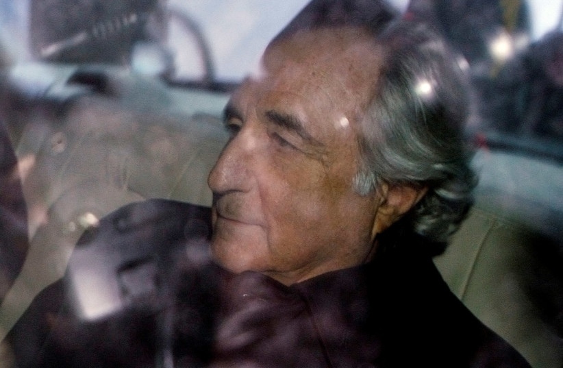 Bernard Madoff is escorted in a vehicle from Federal Court in New York January 5, 2009. (photo credit: LUCAS JACKSON/REUTERS)