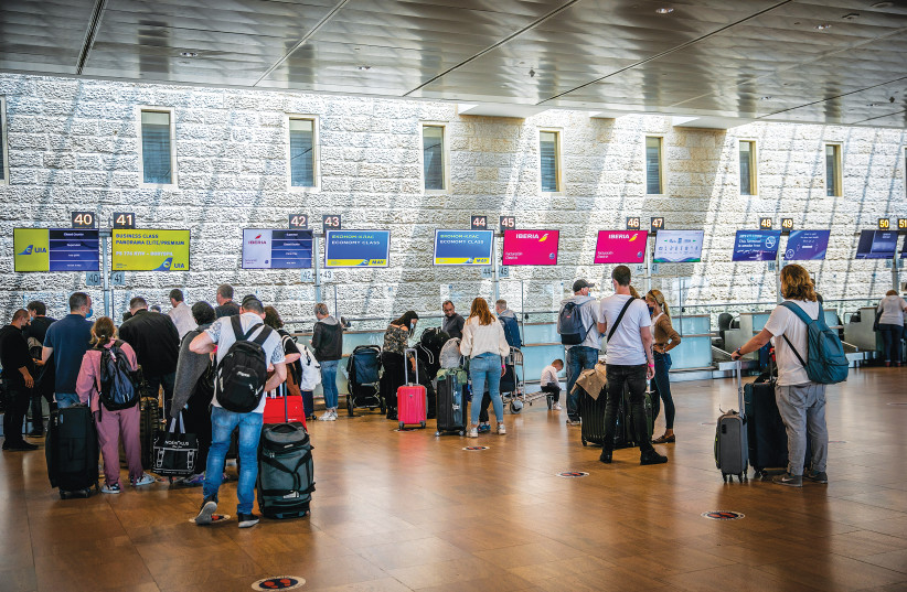 TRAVELERS CONVERGE at Ben-Gurion Airport late last month, as the skies begin to open up. (photo credit: YOSSI ALONI/FLASH90)