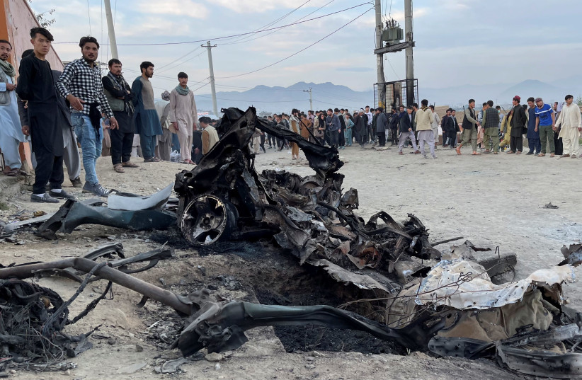 People stand at the site of a blast in Kabul, Afghanistan May 8, 2021. (photo credit: REUTERS/STRINGER)