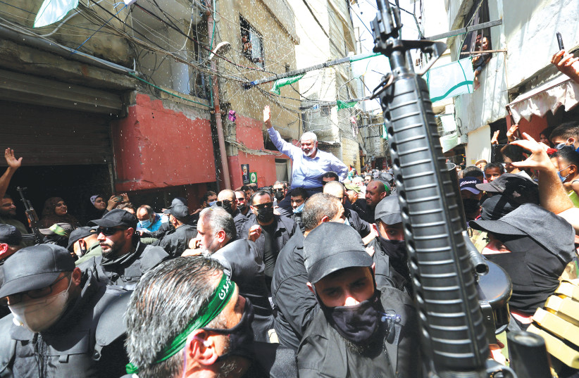 Hamas leader Ismail Haniyeh is carried during a visit to the Ain el Hilweh Palestinian refugee camp in Lebanon in September 2020. (photo credit: AZIZ TAHER/REUTERS)
