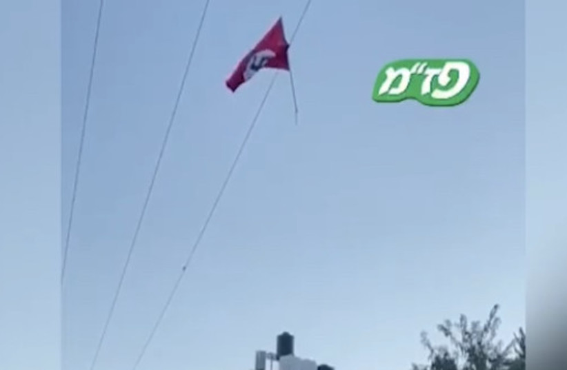 Nazi flag raised in West Bank taken down by IDF. (photo credit: SCREENSHOT/KAN)