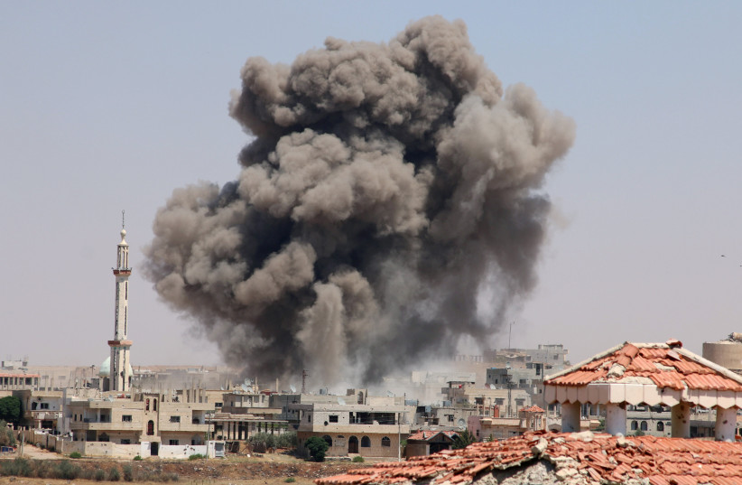  Smoke rises after airstrikes on a rebel-held part of the southern city of Deraa, Syria, June 15, 2017 (illustrative). (photo credit: REUTERS/ALAA AL-FAQIR)
