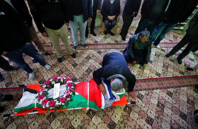 Mourners attend the funeral of Palestinian-American Omar Abdalmajeed As'ad, 80, who was found dead after being detained and handcuffed during an Israeli raid, in Jiljilya village on January 13, 2022. (photo credit: REUTERS/MOHAMAD TOROKMAN)