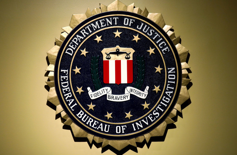  The Federal Bureau of Investigation seal is seen at FBI headquarters before a news conference by FBI Director Christopher Wray on the U.S Justice Department's inspector general's report regarding the actions of the Federal Bureau of Investigation and the 2016 US presidential election in Washington, (photo credit: REUTERS/YURI GRIPAS)