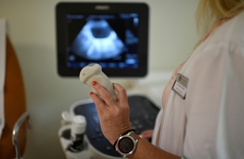  A gynecologist performs an ultrasound scan at Robert Karoly Private Hospital in Budapest, Hungary, July 4, 2019. Picture taken July 4, 2019. (photo credit: REUTERS/TAMAS KASZAS)