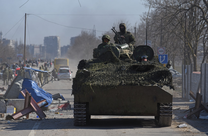  Service members of pro-Russian troops in uniforms without insignia drive an armoured vehicle during Ukraine-Russia conflict in the besieged southern port city of Mariupol, Ukraine March 19, 2022. (photo credit: REUTERS/STRINGER)