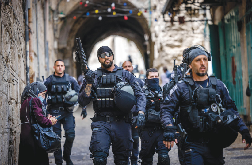  POLICE PATROL outside al-Aqsa Mosque amid clashes in the area this week. (photo credit: YONATAN SINDEL/FLASH90)