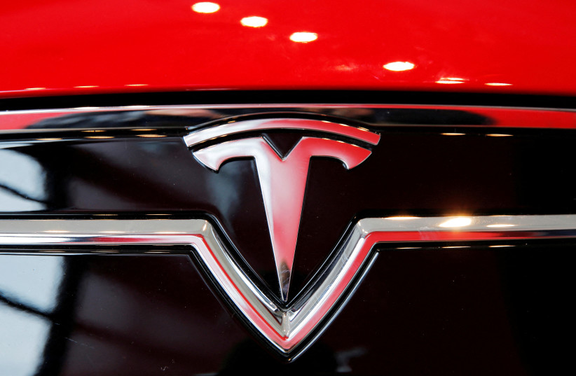 A Tesla logo on a Model S is photographed inside of a Tesla dealership in New York, US, April 29, 2016. (photo credit: REUTERS/LUCAS JACKSON/FILE PHOTO)