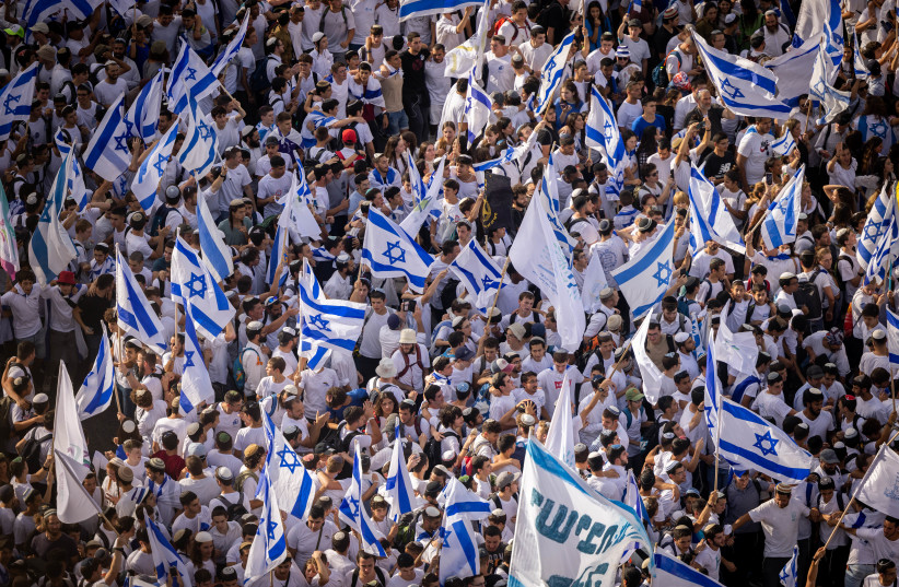  Thousands of Jews wave Israeli flags as they celebrate Jerusalem Day by dancing at Damascus Gate in Jerusalem's Old City, during Jerusalem Day, May 29, 2022 (photo credit: YONATAN SINDEL)