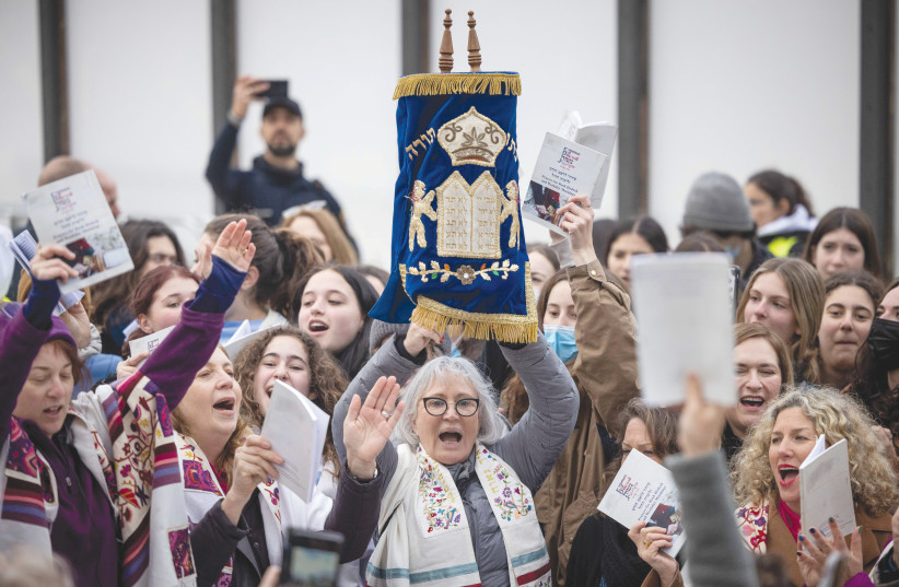  A WOMAN holds up a Torah scroll as members of Women of the Wall and the Conservative and Reform movements chant and pray on Rosh Hodesh Adar II at the Kotel, in March.   (photo credit: YONATAN SINDEL/FLASH90)