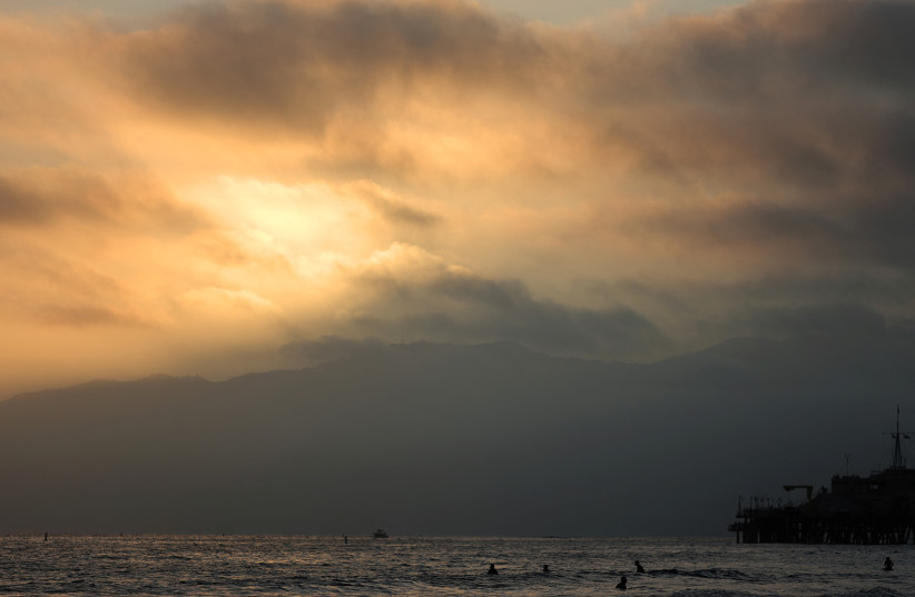  The sun sets over the Pacific Ocean on the summer solstice in Santa Monica, California, U.S., June 21, 2022. (photo credit: REUTERS/LUCY NICHOLSON)