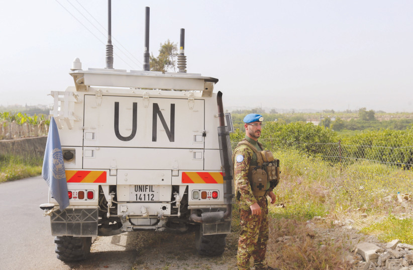  A UNIFIL peacekeeper stands next to a UN vehicle in southern Lebanon, in April (photo credit: AZIZ TAHER/REUTERS)