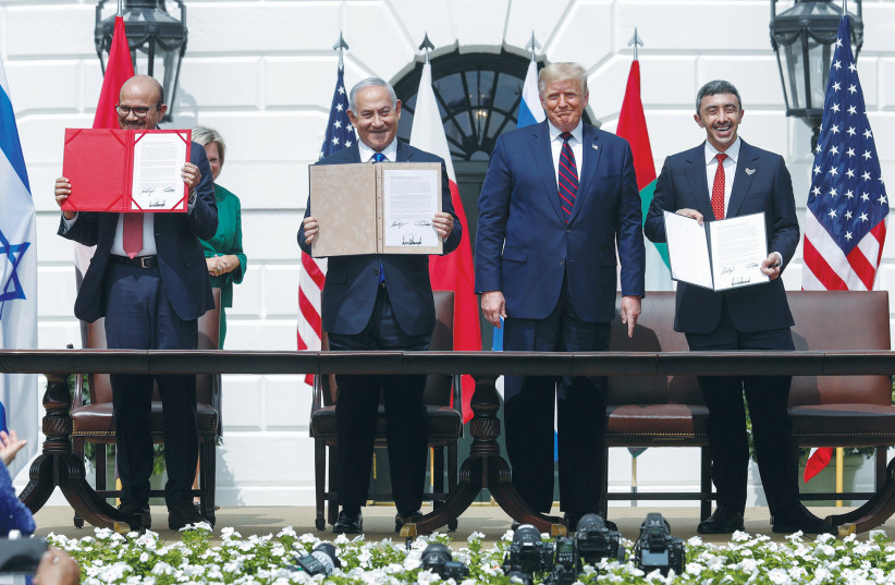  AFTER SIGNING the Abraham Accords, then-prime minister Benjamin Netanyahu and the foreign ministers of Bahrain (left) and UAE display their copies as then-US president Donald Trump looks on, at the White House, September 15, 2020. (photo credit: TOM BRENNER/REUTERS)