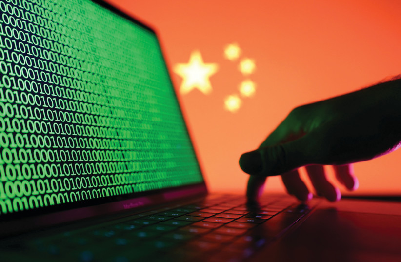  A LAPTOP with binary codes displayed in front of the Chinese flag. Individuals basically do not care if their personal data are stolen, unless the hacker personally locks them out of their accounts or the theft has some other major concrete negative impact on their lives. (photo credit: DADO RUVIC/REUTERS)