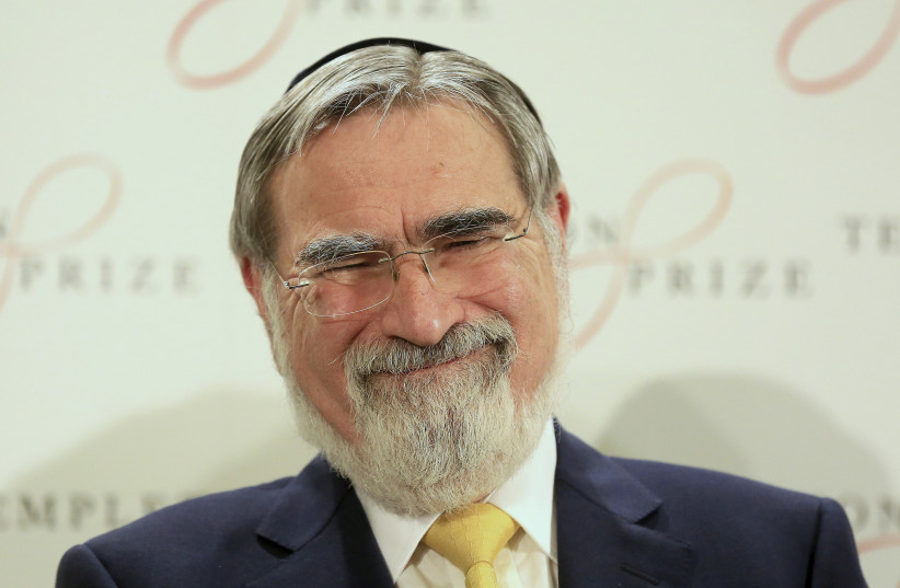 Britain's former Chief Rabbi Jonathan Sacks laughs during a news conference after being awarded the 2016 Templeton Prize in London, Britain, March 2, 2016. (photo credit: REUTERS/PAUL HACKETT)