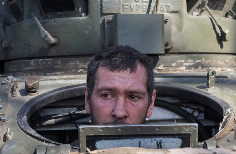  A Ukrainian serviceman looks out from a Bradley Fighting Vehicle (BFV), as Russia's attack on Ukraine continues, near the town of Izium, recently liberated by Ukrainian Armed Forces, in Kharkiv region, Ukraine September 19, 2022. (photo credit: GLEB GARANICH/REUTERS)