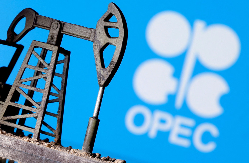  A 3D-printed oil pump jack is seen in front of displayed OPEC logo in this illustration picture, April 14, 2020. (photo credit: REUTERS/DADO RUVIC/FILE PHOTO)
