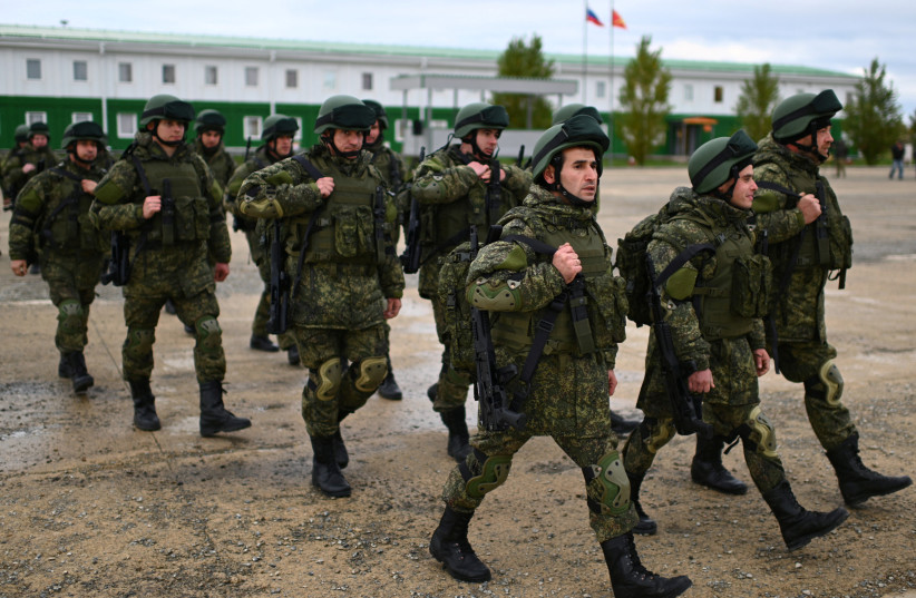  Russian reservists recruited during the partial mobilisation of troops attend a ceremony before departing to the zone of Russia-Ukraine conflict, in the Rostov region, Russia October 31, 2022.  (photo credit: REUTERS/SERGEY PIVOVAROV)